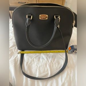 Michael Kors Black handbag with messenger strap.